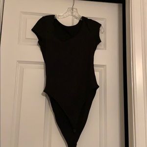 Black body suit, button underneath, square chest